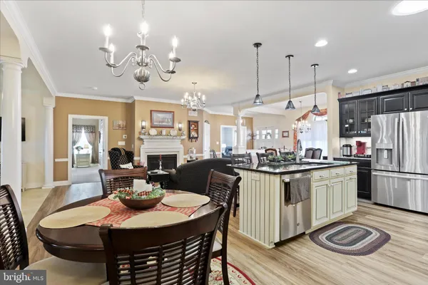 a living room with furniture a fireplace and a chandelier