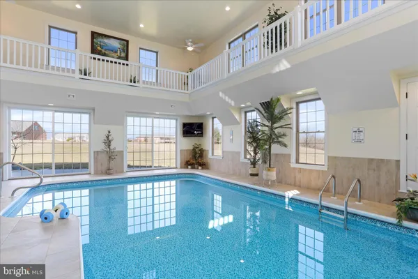 a view of a dining room with furniture a chandelier and wooden floor