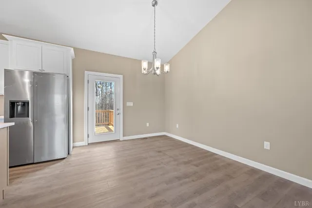a view of a kitchen with refrigerator and windows