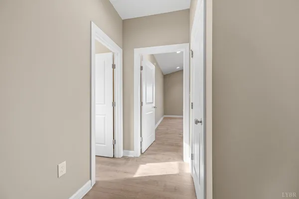 a view of a hallway with a wooden door