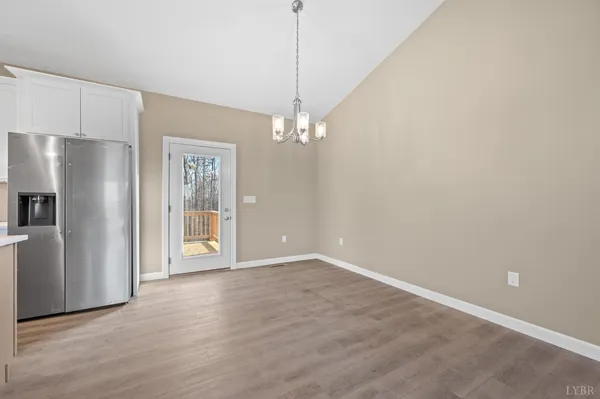 a view of a kitchen with refrigerator and windows