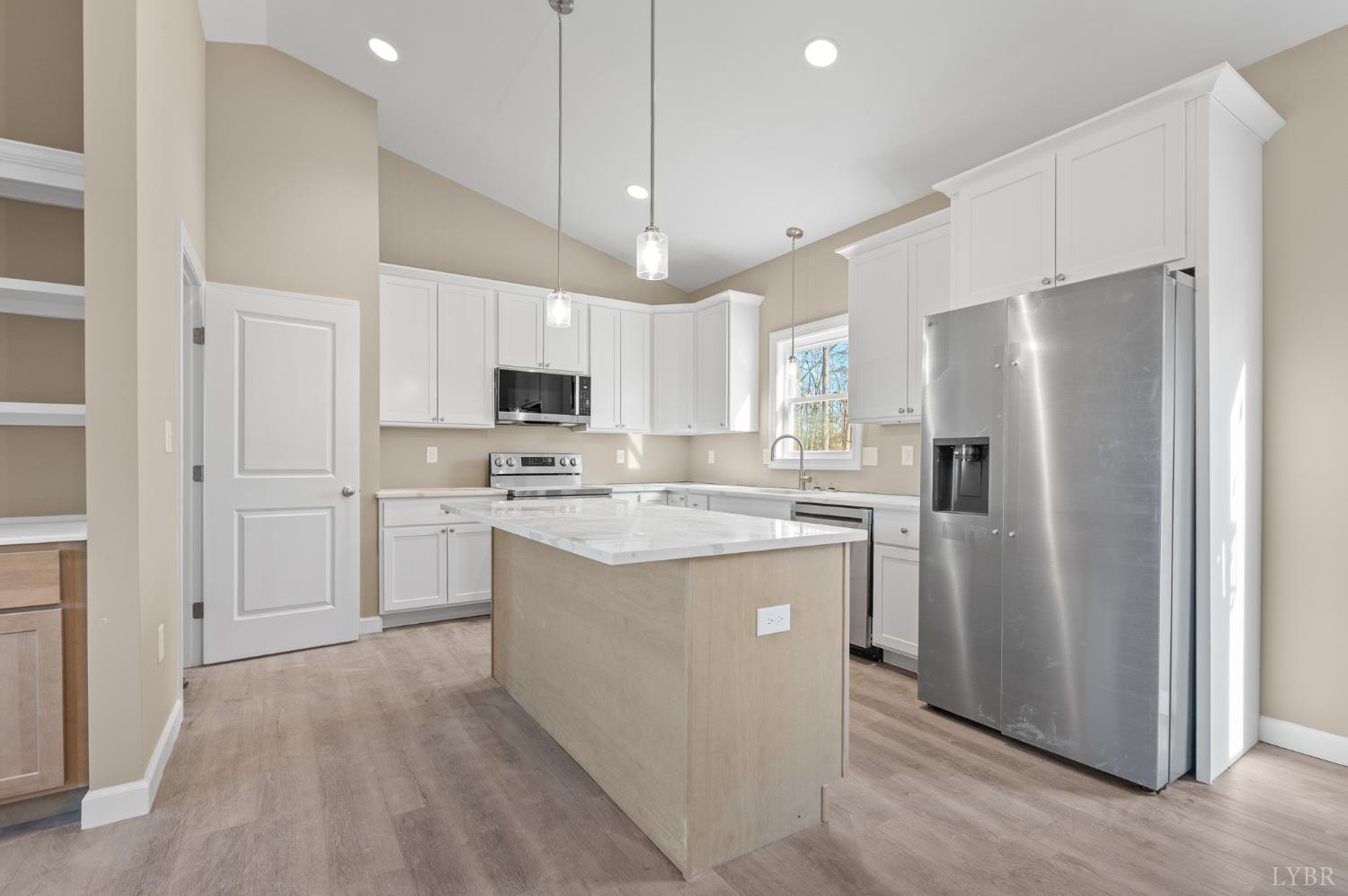 1720 Oak Rdg Road Appomattox, VA 24522 - Photo 16 of 53 a kitchen with kitchen island granite countertop a refrigerator a sink dishwasher a stove and white cabinets with wooden floor