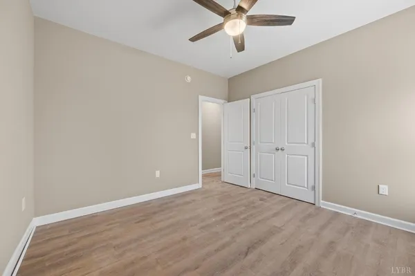 a view of an empty room with wooden floor