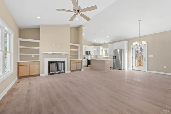a view of a livingroom with a fireplace and cabinet