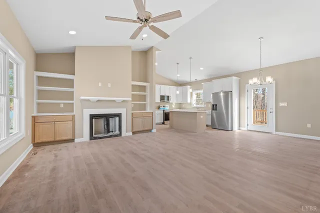 a view of a livingroom with a fireplace and cabinet