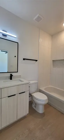 a bathroom with a double vanity sink toilet and mirror