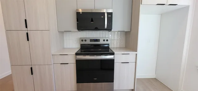 a kitchen with a stove and a refrigerator
