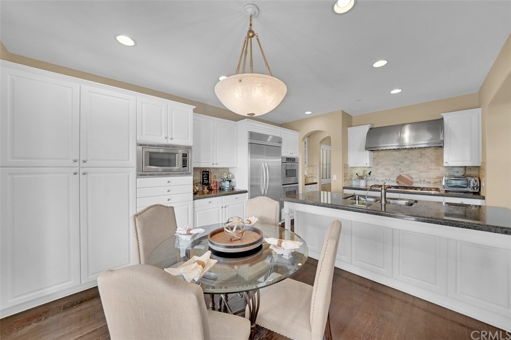 31 Via Soria San Clemente, CA 92673 - Photo 5 of 59 a kitchen with sink a stove and white cabinets