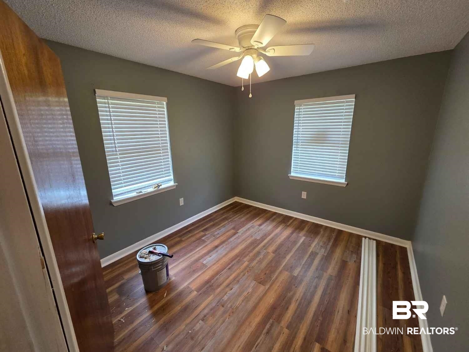 106 West 16th Street Bay Minette, AL 36507 - Photo 16 of 19 Spare room featuring wood finished floors, plenty of natural light, a textured ceiling, and baseboards