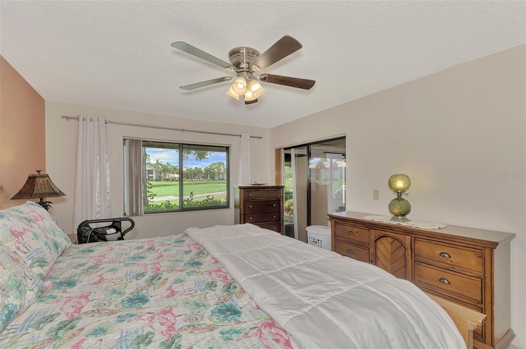 4521 Kingsmere, Unit 6 Sarasota, FL 34235 - Photo 22 of 42 a bedroom with a bed and a chandelier