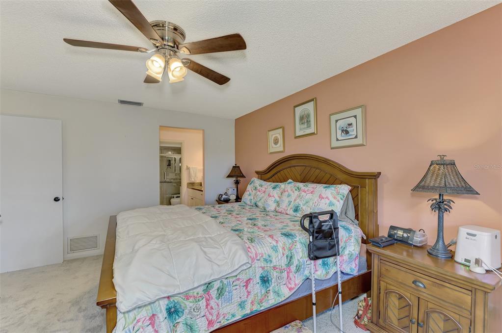 4521 Kingsmere, Unit 6 Sarasota, FL 34235 - Photo 23 of 42 a bedroom with a bed and wooden floor