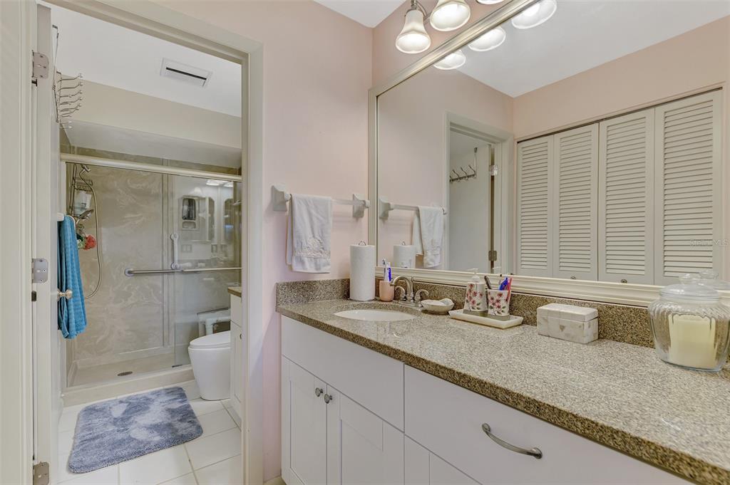 4521 Kingsmere, Unit 6 Sarasota, FL 34235 - Photo 25 of 42 a bathroom with double vanity and a shower