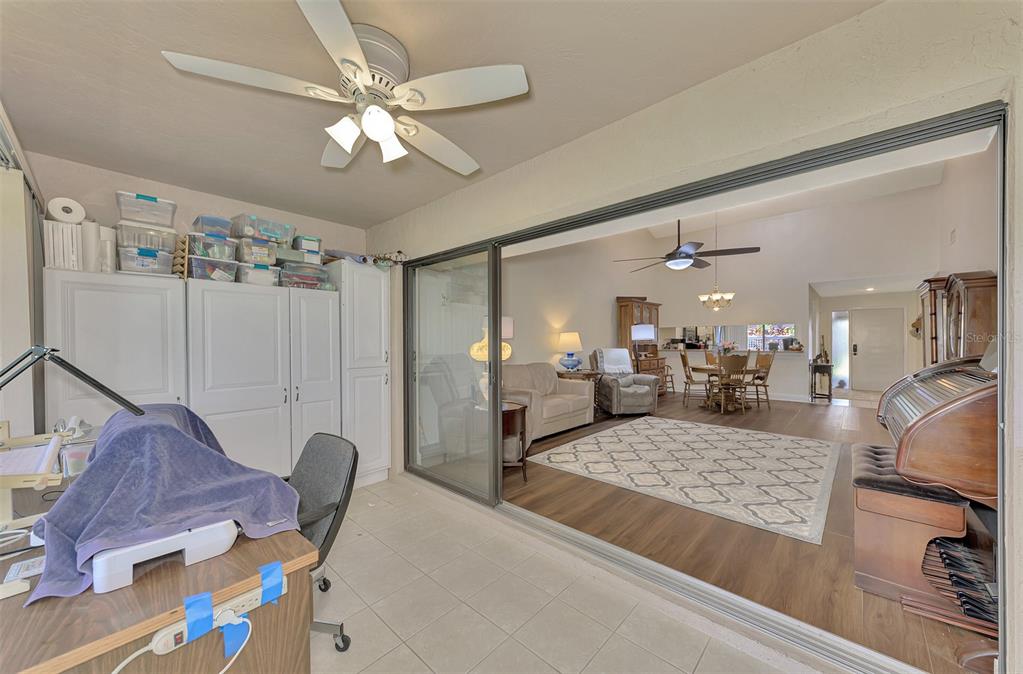 4521 Kingsmere, Unit 6 Sarasota, FL 34235 - Photo 31 of 42 a living room with furniture and a chandelier
