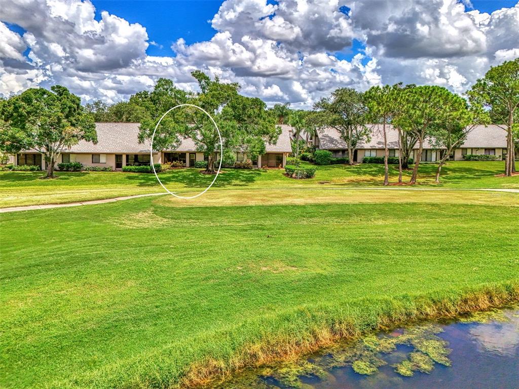 4521 Kingsmere, Unit 6 Sarasota, FL 34235 - Photo 38 of 42 a view of a fountain in front of a house with a big yard