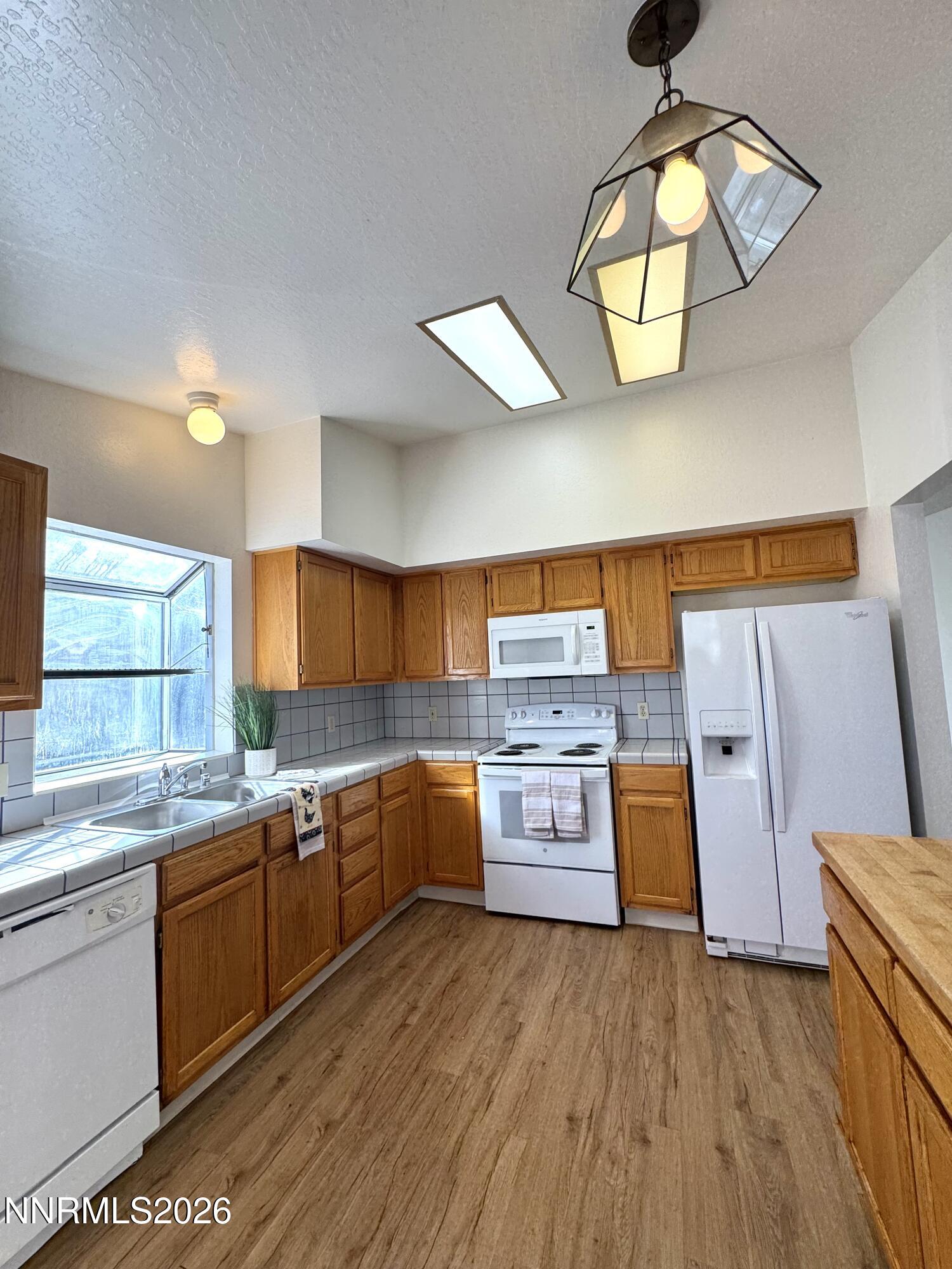 6052 Walnut Creek Road Reno, NV 89523 - Photo 2 of 11 a kitchen with cabinets a sink and appliances