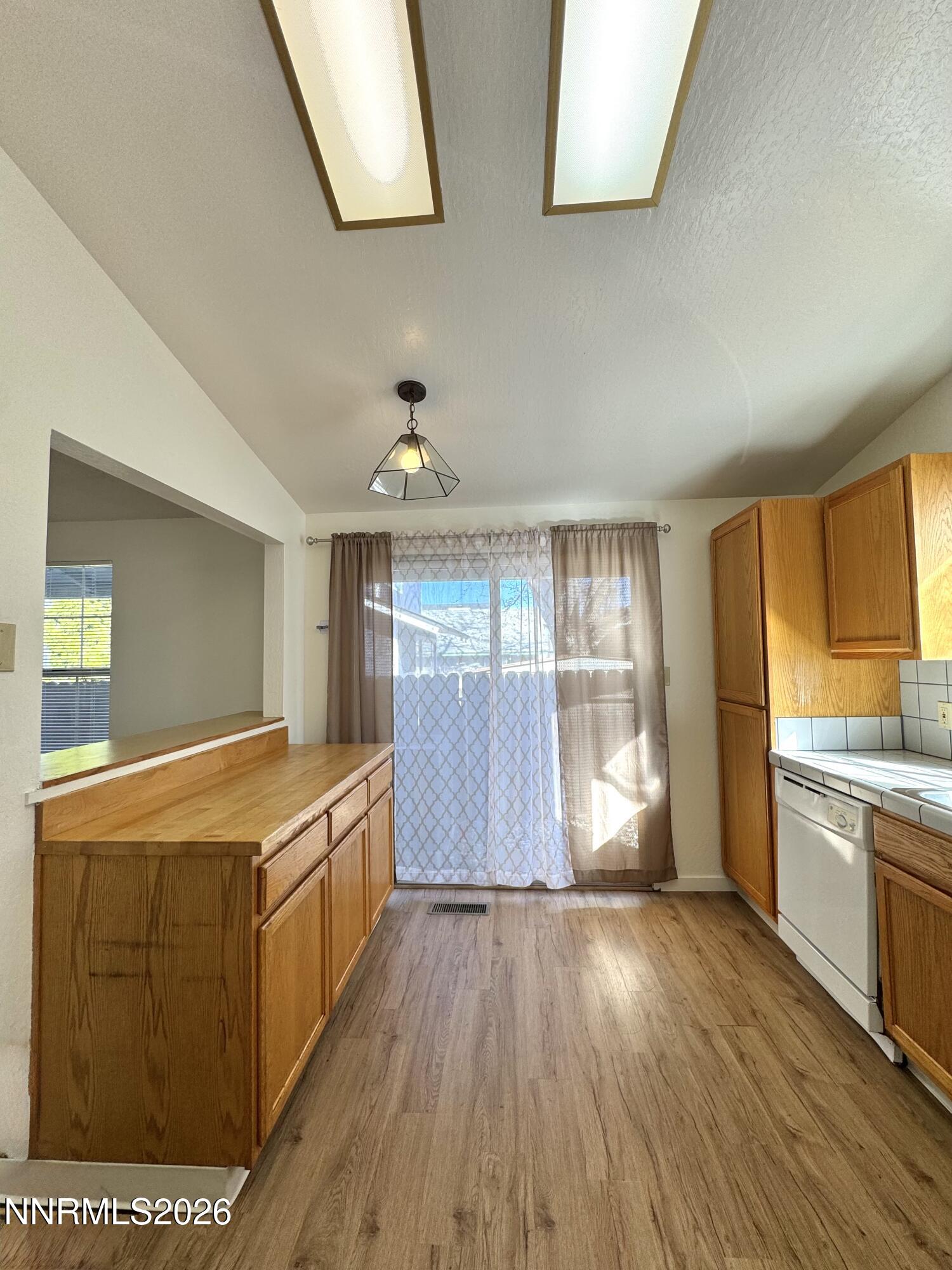 6052 Walnut Creek Road Reno, NV 89523 - Photo 3 of 11 a view of a kitchen with wooden floor and electronic appliances