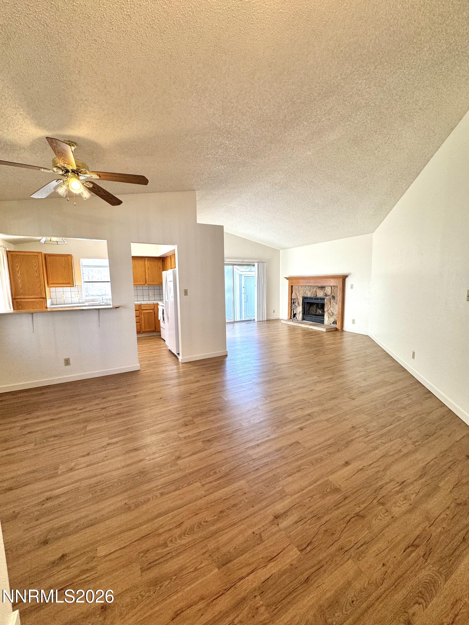 6052 Walnut Creek Road Reno, NV 89523 - Photo 5 of 11 an empty room with wooden floor and windows