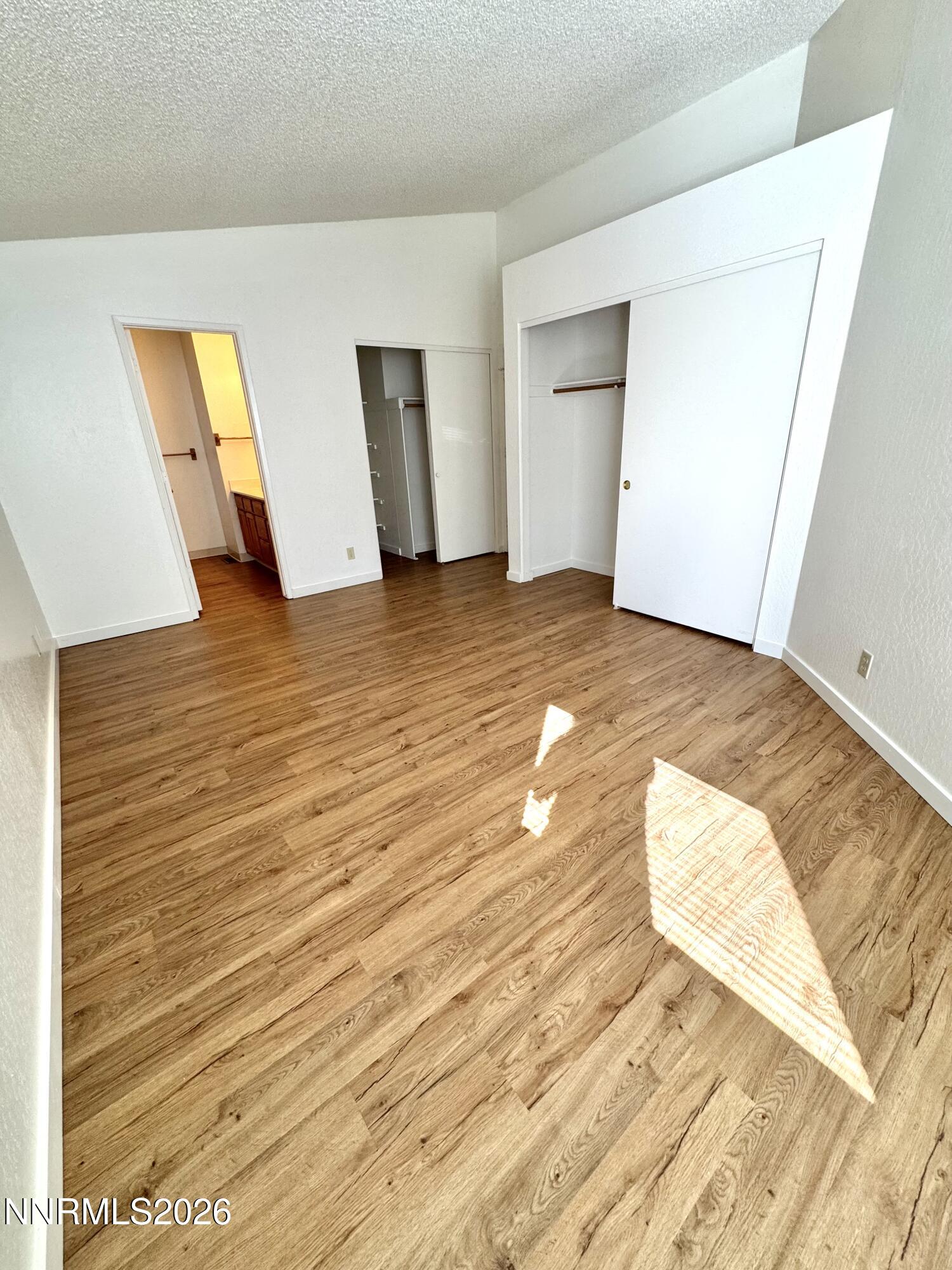 6052 Walnut Creek Road Reno, NV 89523 - Photo 7 of 11 a view of a room with wooden floor and staircase