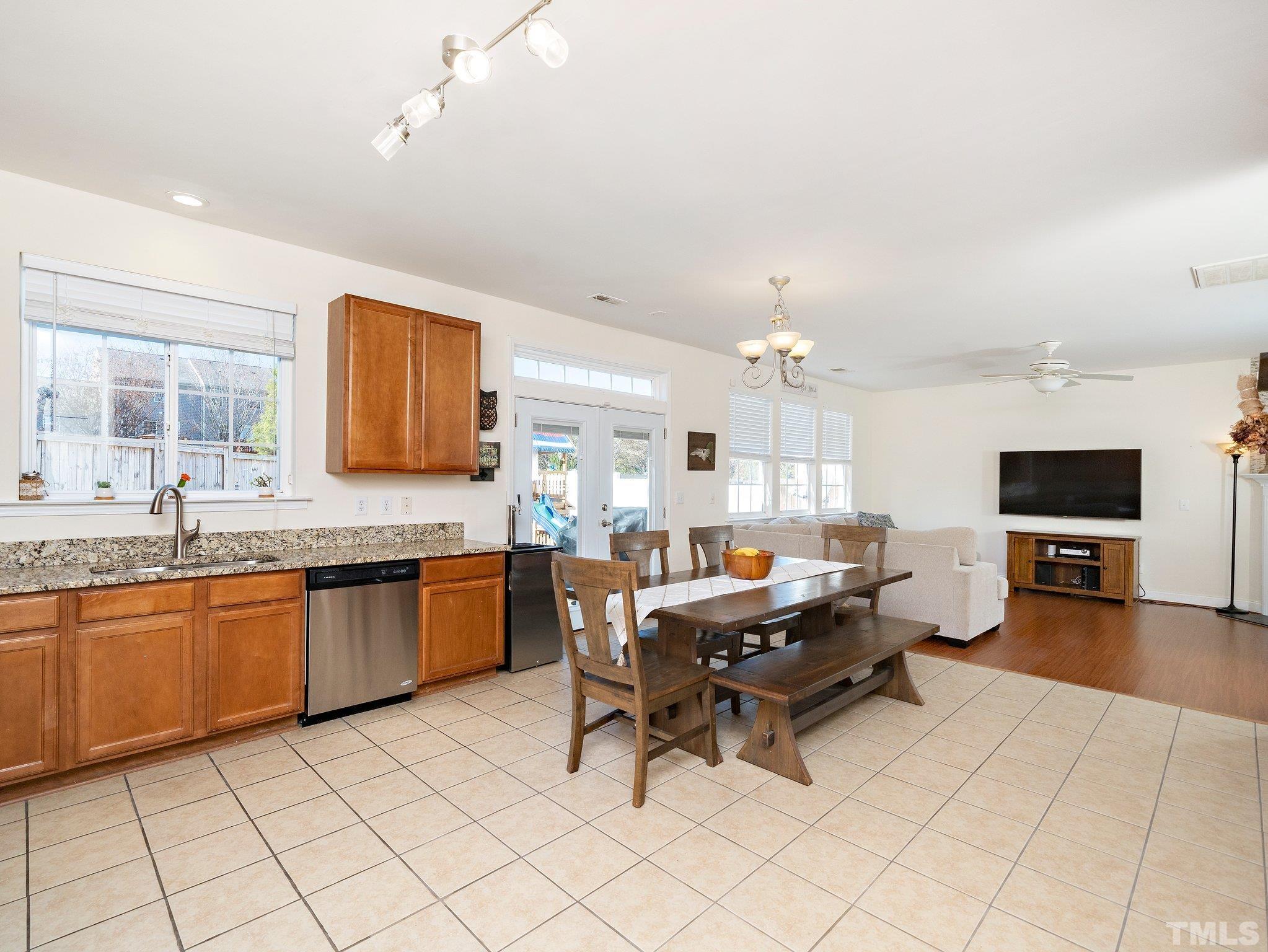 8803 Elizabeth Bennet Place Raleigh, NC 27616 - Photo 14 of 23 a large living room with granite countertop furniture a flat screen tv and kitchen view