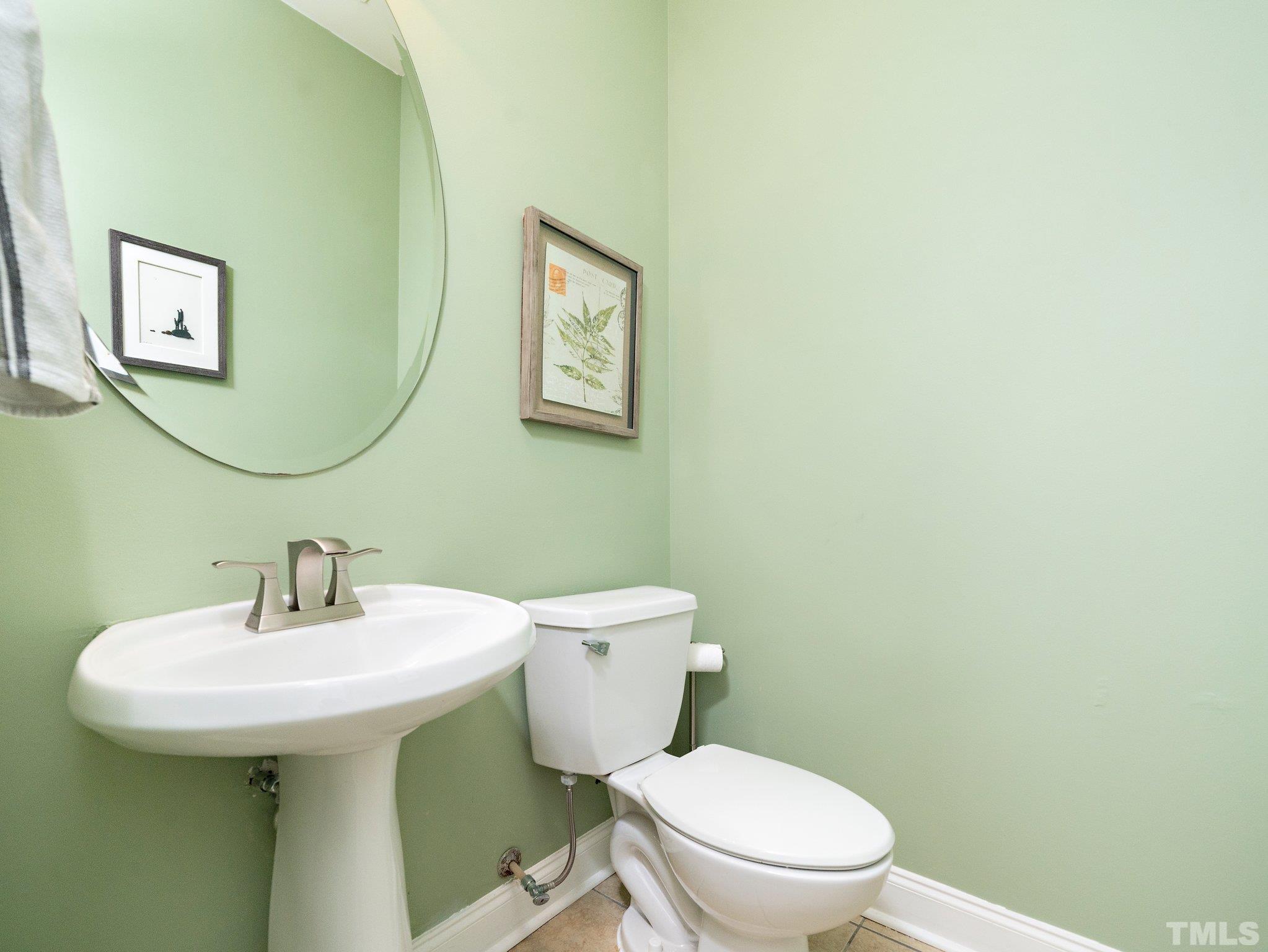 8803 Elizabeth Bennet Place Raleigh, NC 27616 - Photo 15 of 23 a bathroom with a toilet sink and mirror