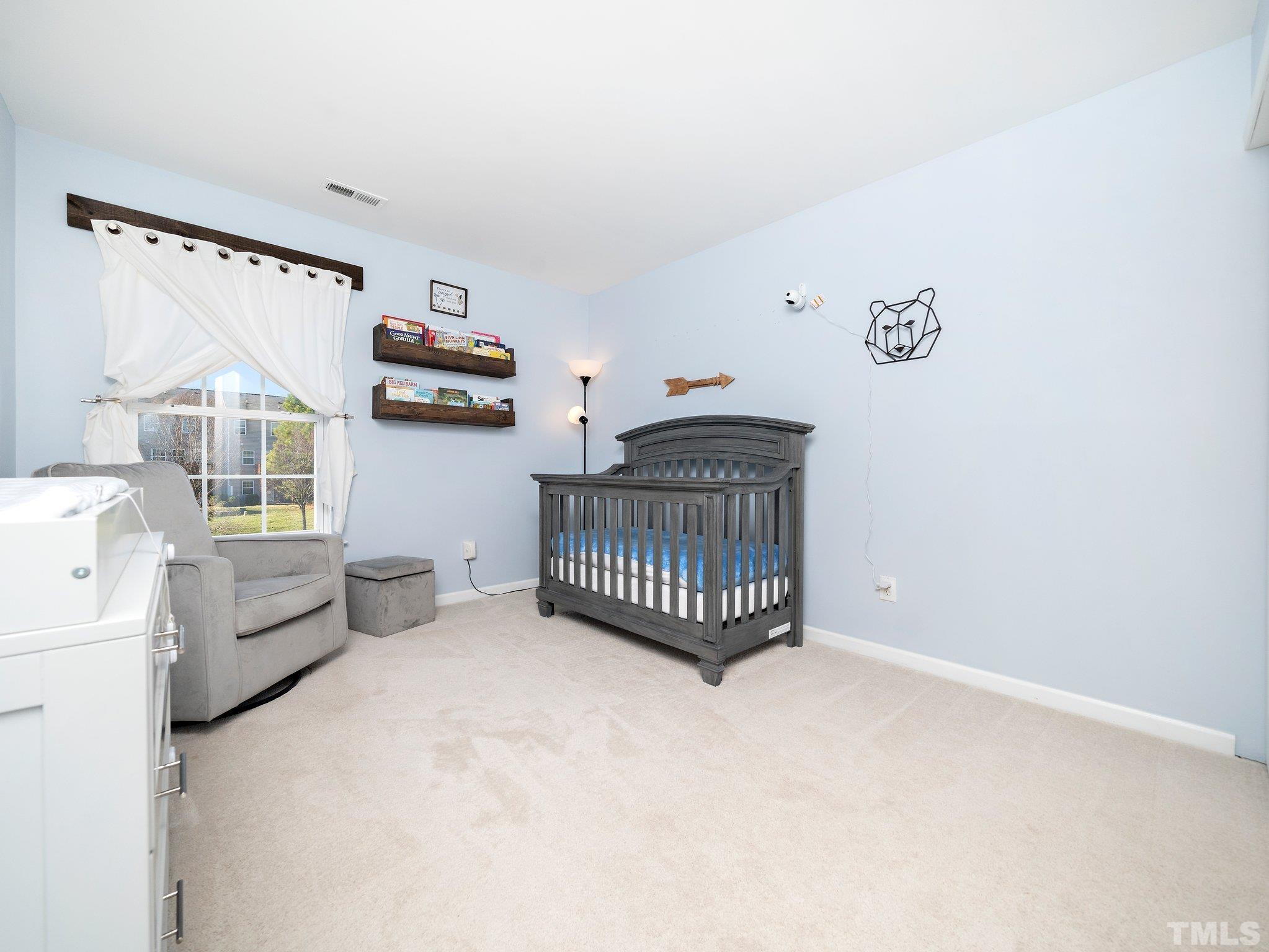 8803 Elizabeth Bennet Place Raleigh, NC 27616 - Photo 20 of 23 a bedroom with furniture and window
