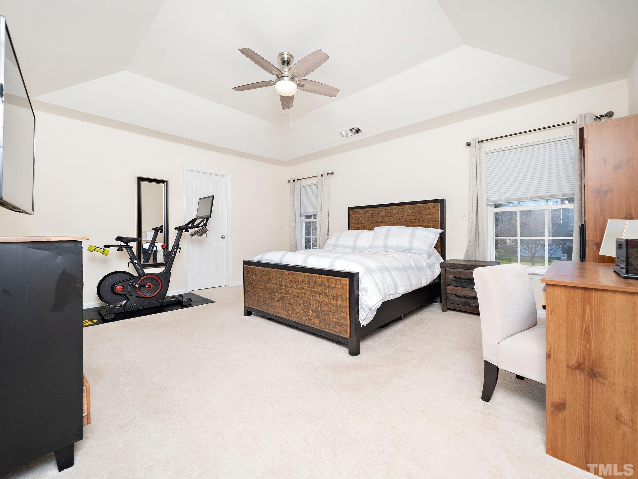 8803 Elizabeth Bennet Place Raleigh, NC 27616 - Photo 21 of 23 a bedroom with a bed and a chandelier