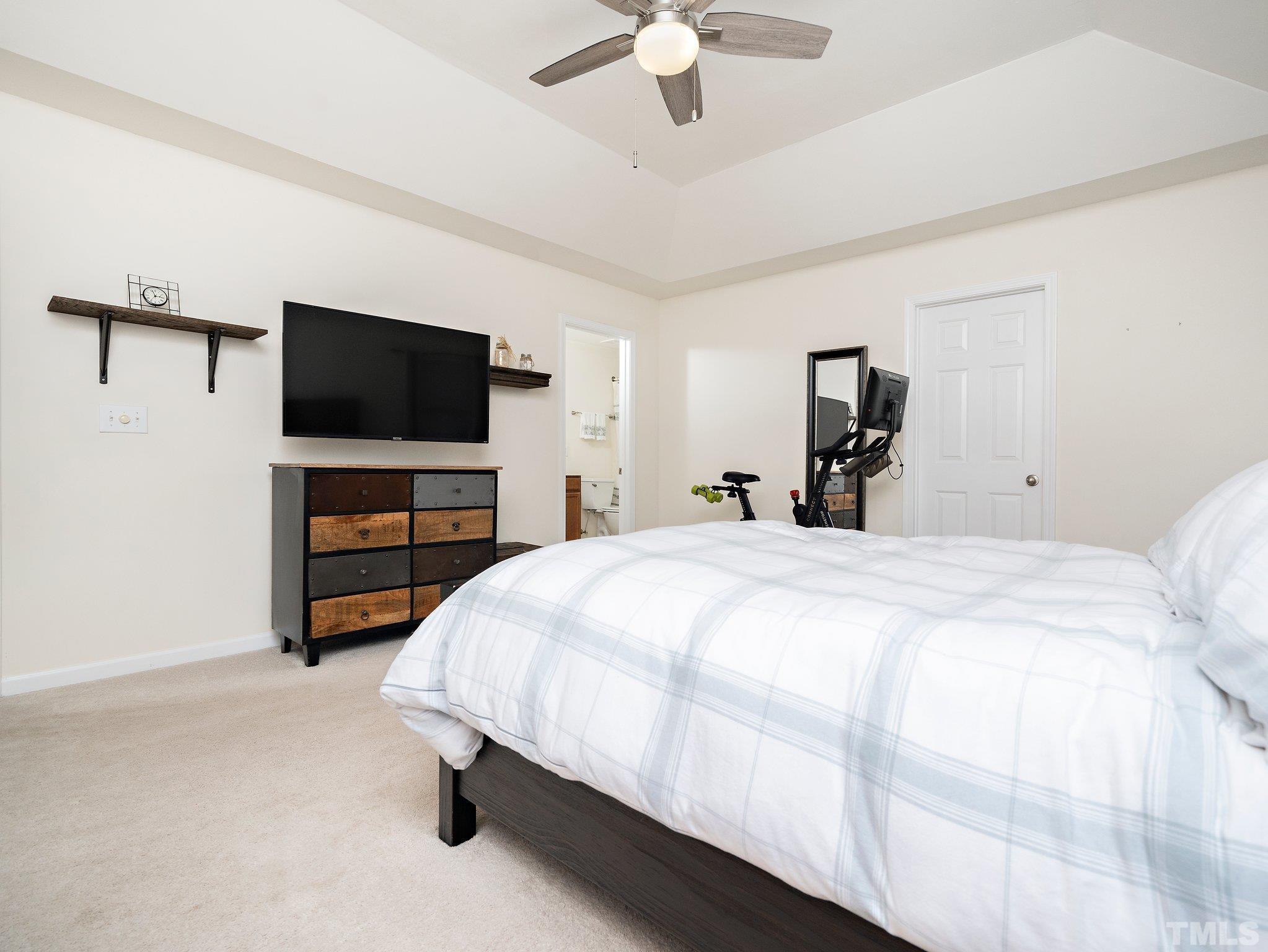 8803 Elizabeth Bennet Place Raleigh, NC 27616 - Photo 23 of 23 a bedroom with a bed and a flat screen tv