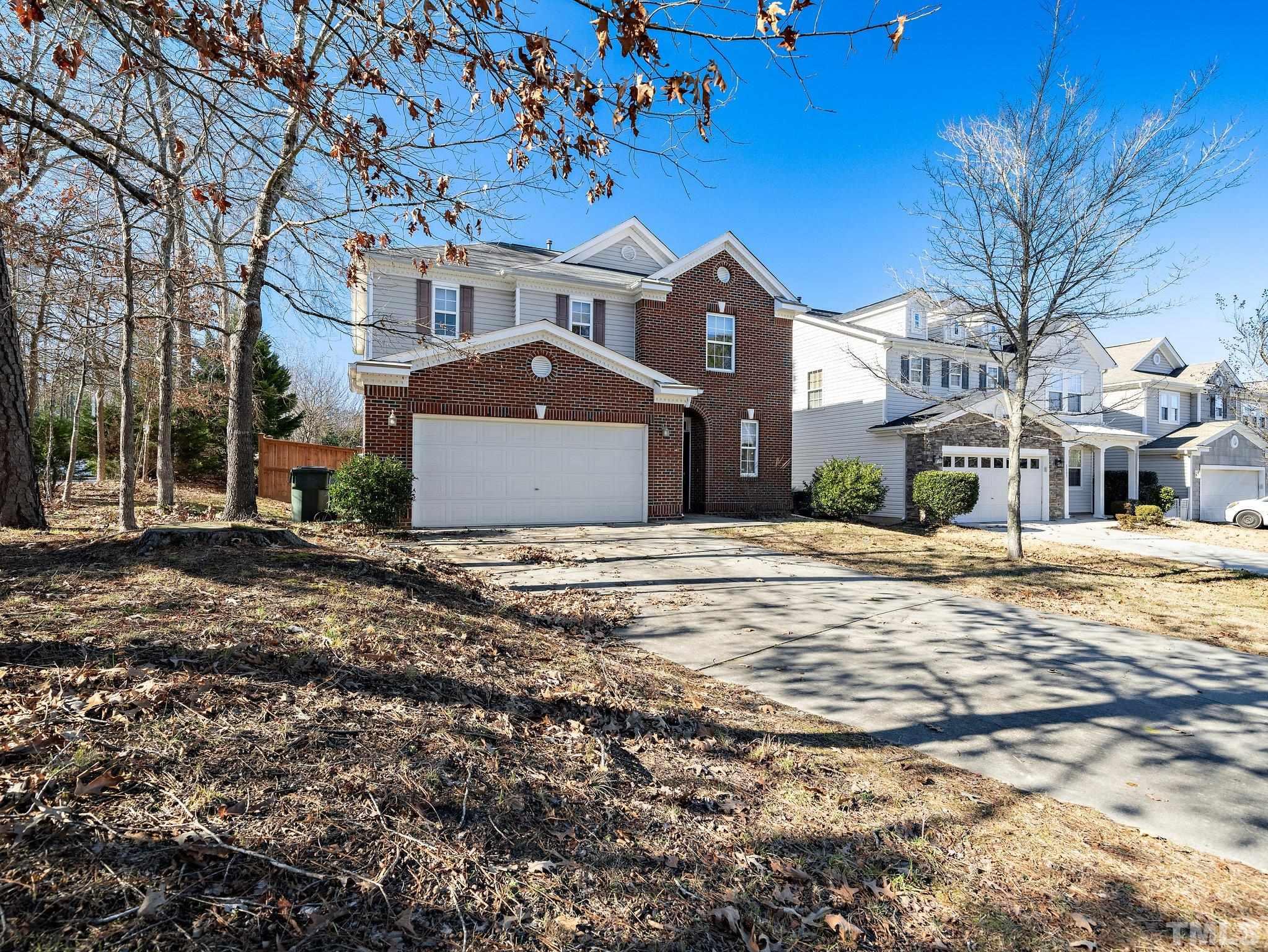 8803 Elizabeth Bennet Place Raleigh, NC 27616 - Photo 3 of 23 a front view of a building with a yard