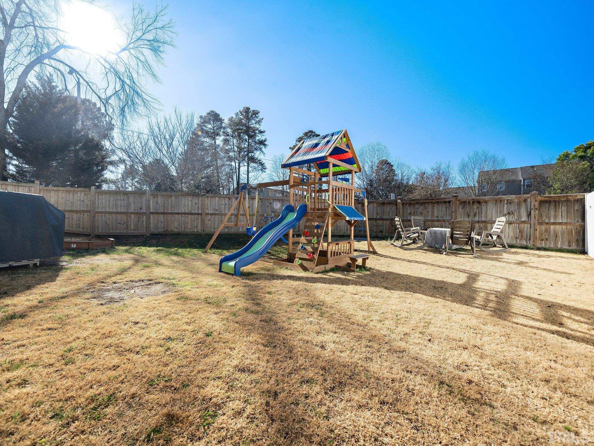 8803 Elizabeth Bennet Place Raleigh, NC 27616 - Photo 4 of 23 a view of a park with swings and slides