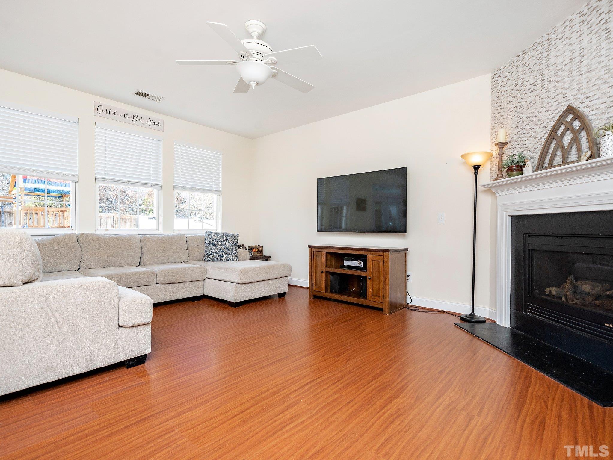 8803 Elizabeth Bennet Place Raleigh, NC 27616 - Photo 8 of 23 a living room with furniture and a fireplace