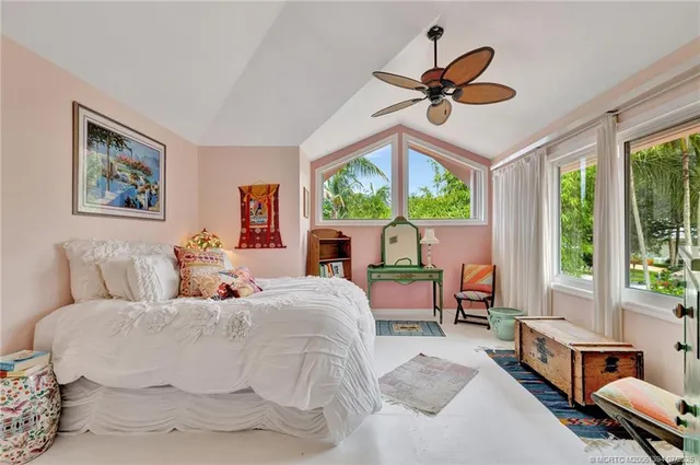 a bedroom with a bed and a large window