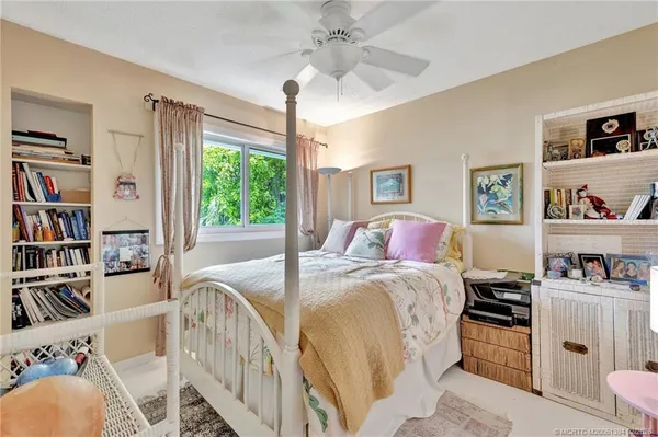 a bed room with a bed and a book shelf