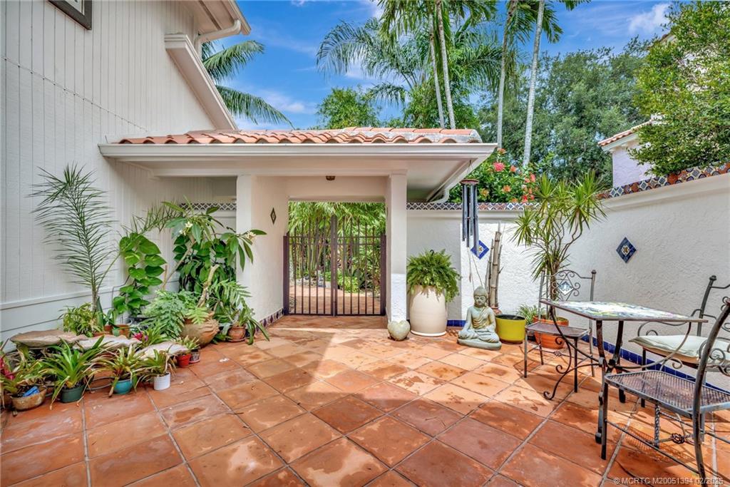 221 Coconut Avenue Stuart, FL 34996 - Photo 4 of 20 a view of a white building with a large window and potted plants