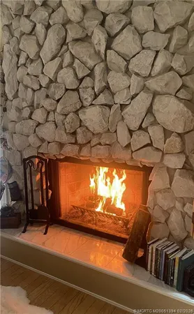 a view of a room with wooden floor and windows