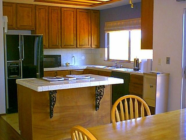 2550 Ruby Court Redding, CA 96001 - Photo 4 of 5 a kitchen with a sink a stove and a refrigerator