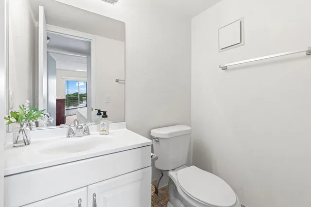 a bathroom with a sink toilet and a mirror