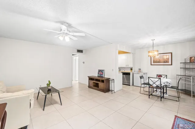 a living room with furniture a dining table and chairs with wooden floor