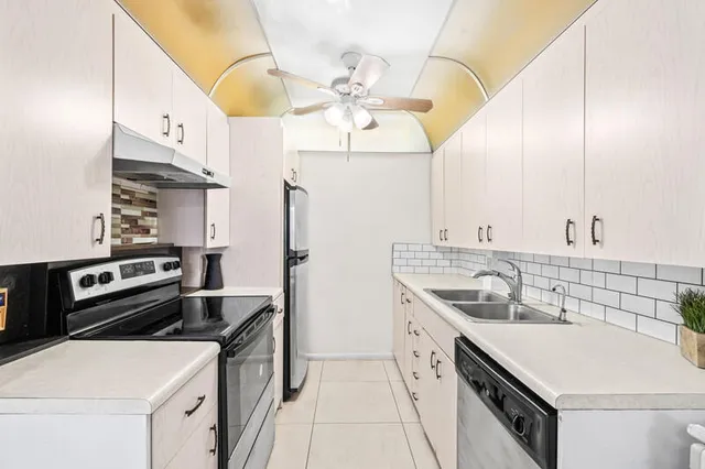 a kitchen that has a sink and a stove