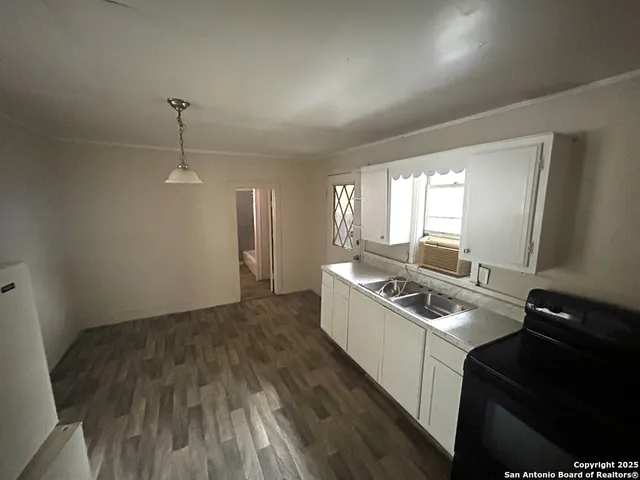 a kitchen that has a sink and a stove