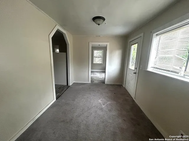 an empty room with windows and closet