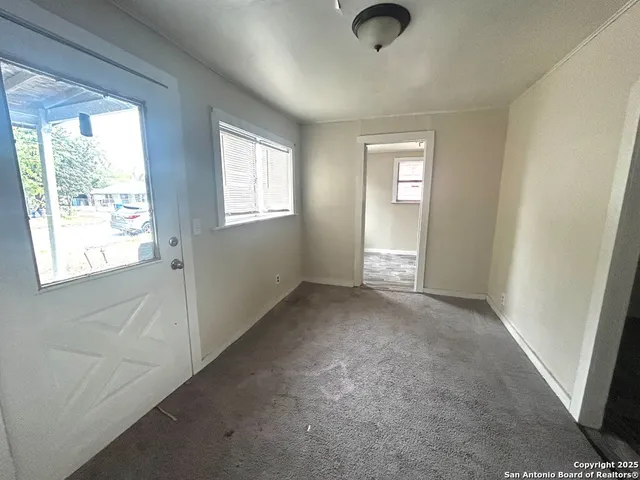 an empty room with windows and closet