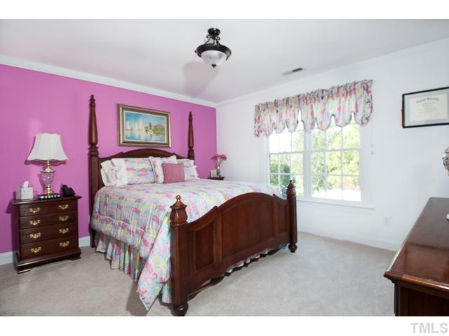 502 Mason Road Durham, NC 27712 - Photo 18 of 25 a bedroom with a bed and a window