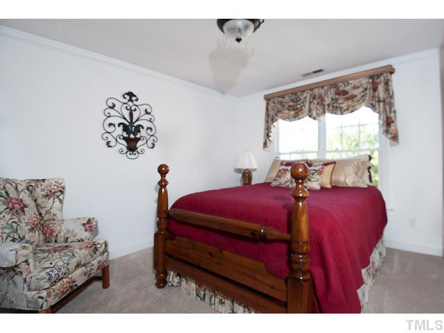 502 Mason Road Durham, NC 27712 - Photo 19 of 25 a bed room with a bed and a chair