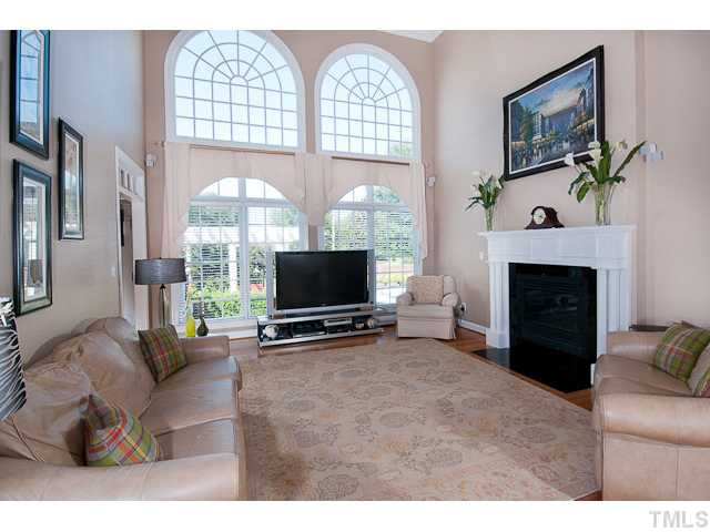 502 Mason Road Durham, NC 27712 - Photo 8 of 25 a living room with furniture a large window and a flat screen tv