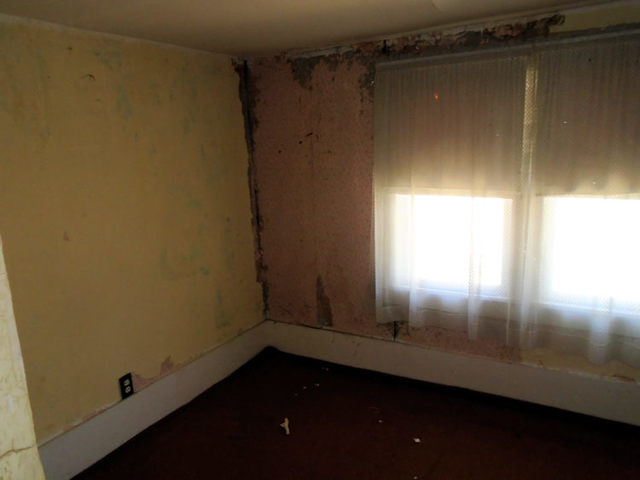 1012 North 8th Street Rochelle, IL 61068 - Photo 7 of 9 a view of an empty room with wooden floor and a window