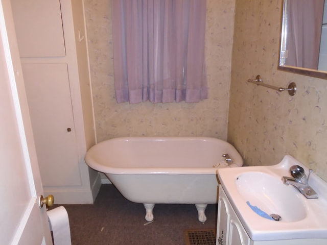 1012 North 8th Street Rochelle, IL 61068 - Photo 9 of 9 a bathroom with a sink and bathtub
