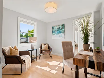 a living room with furniture and a potted plant