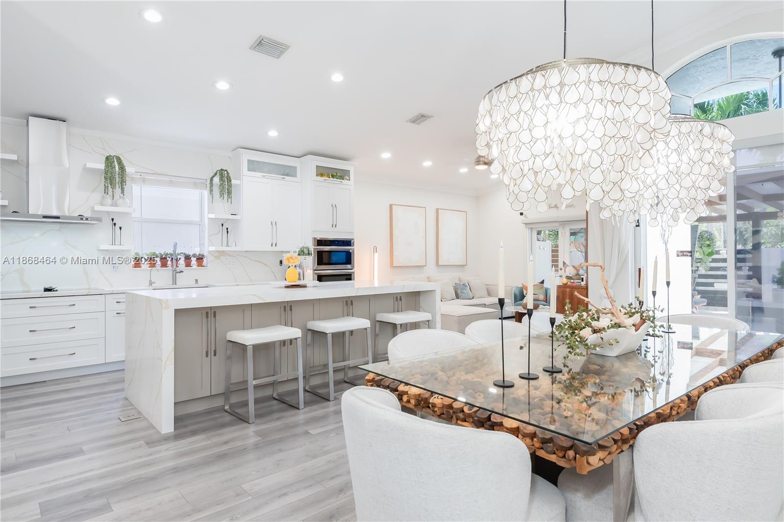 13348 Southwest 52nd Street Miramar, FL 33027 - Photo 11 of 48 a kitchen with kitchen island granite countertop a table and chairs in it