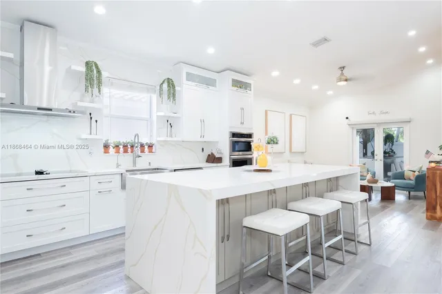 a large kitchen with a lot of counter space and stainless steel appliances
