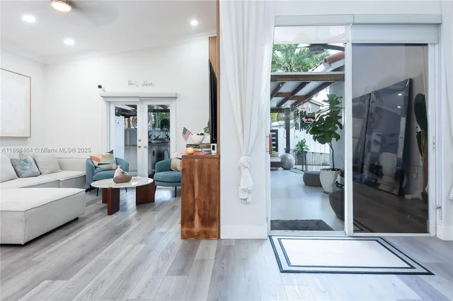 a living room with furniture a fireplace and kitchen view